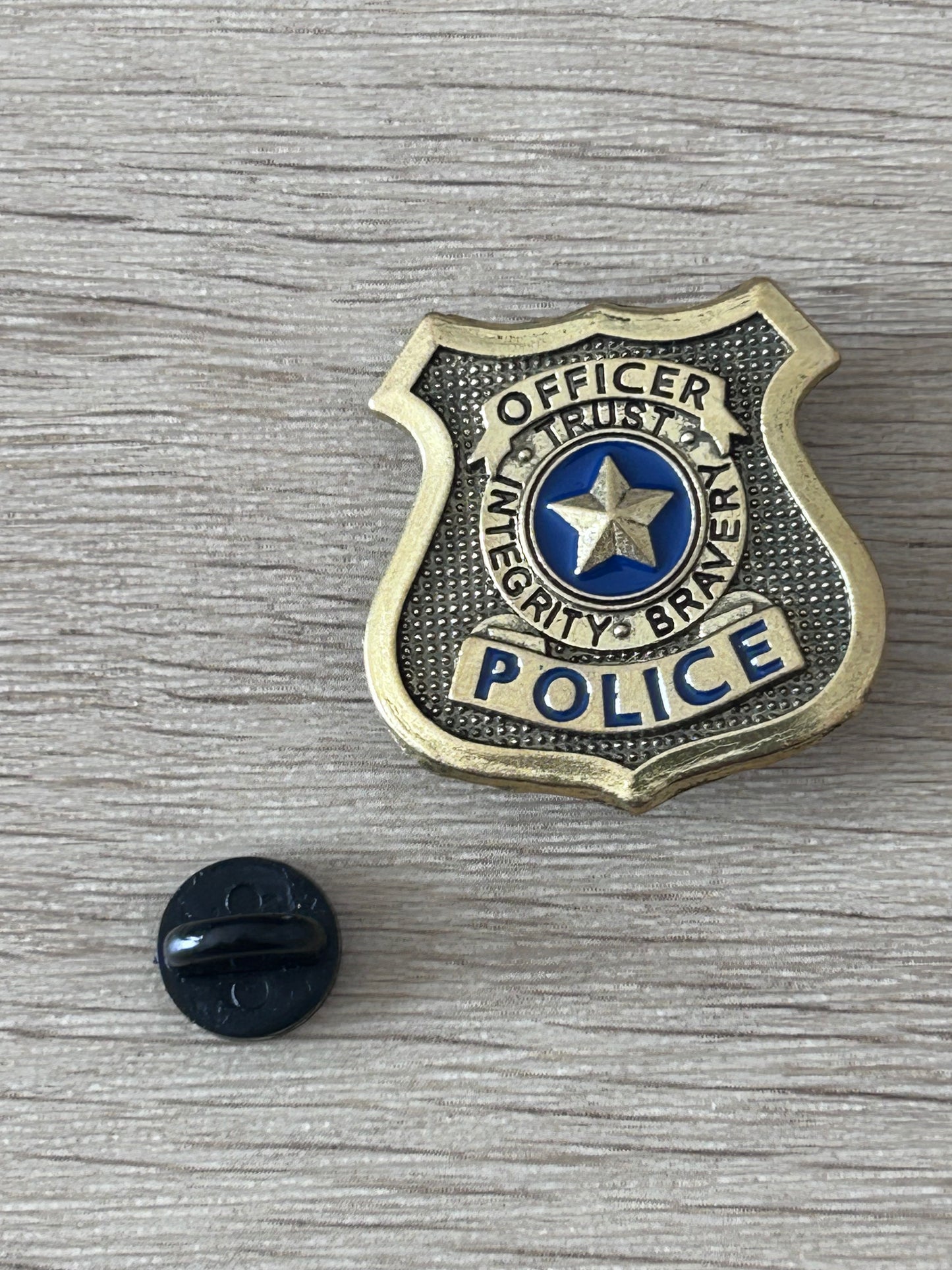 Badge de police américain écusson doré avec étoile bleue; dos noir de fixation visible