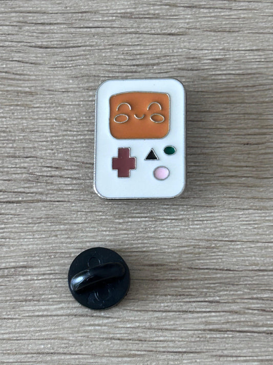 Pin’s console portable kawaii émail bleu clair, manette brune, boutons + vert et rose.