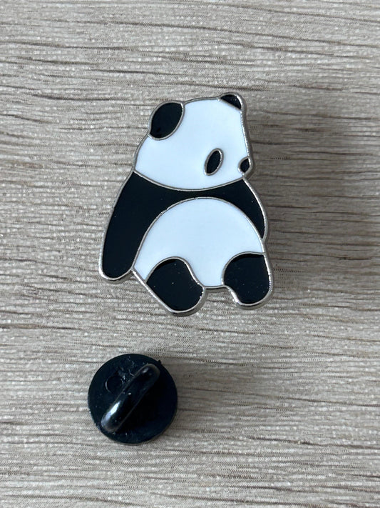 Pin's panda assis émaillé noir et blanc, attache arrière noire visible.