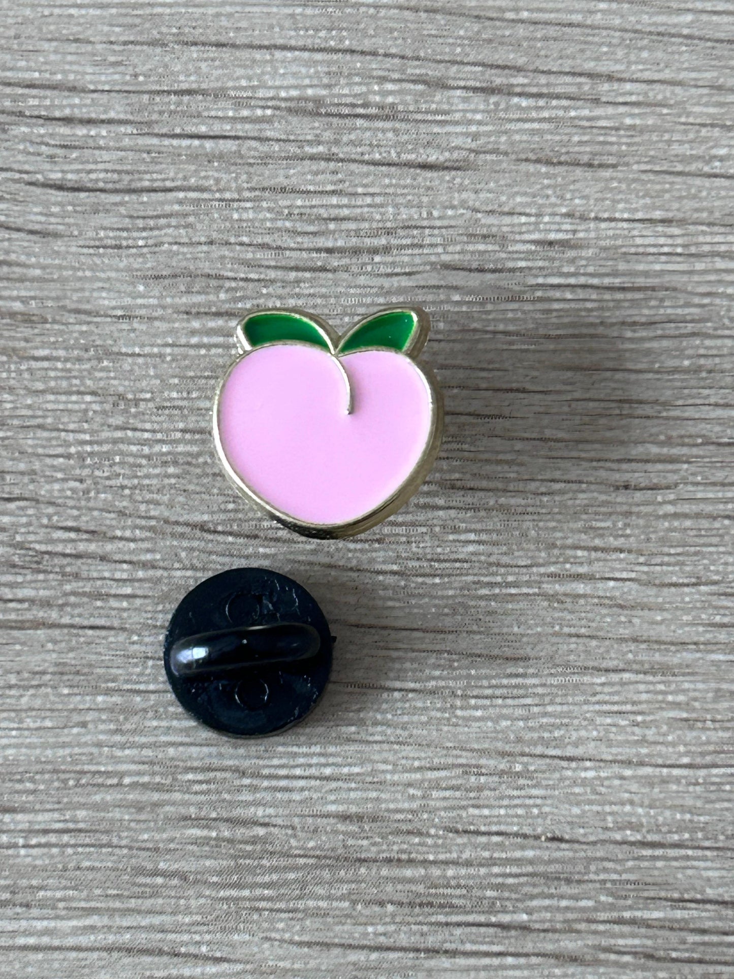 Deux pins : pêche rose émaillée avec feuilles vertes et pin rond sombre