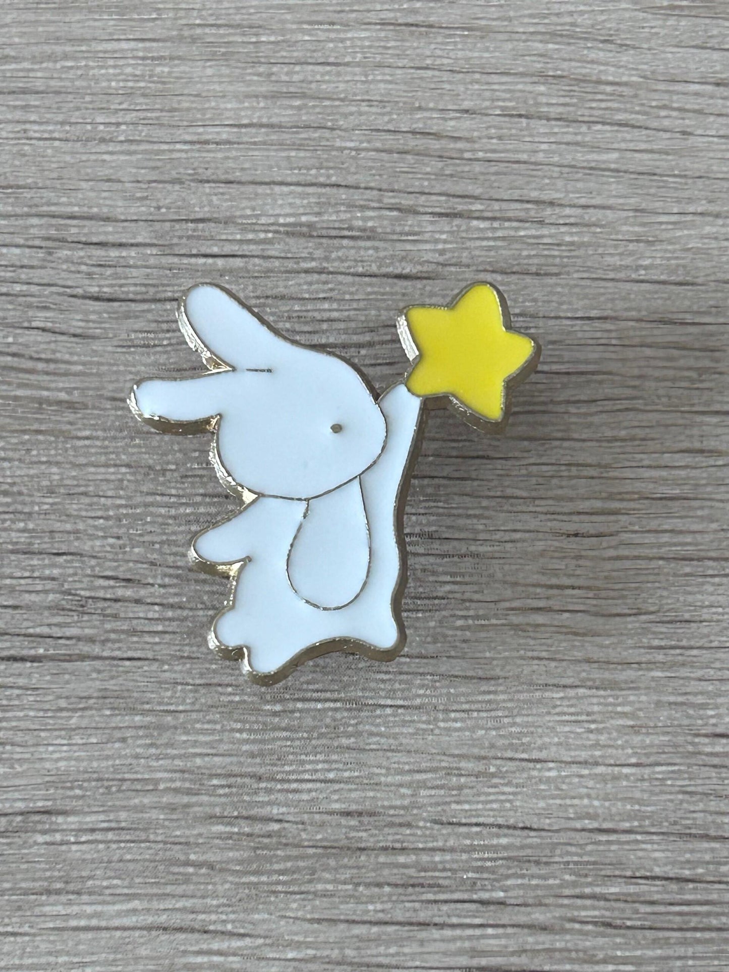 Broche lapin bleu clair tenant une étoile jaune