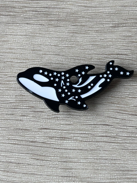 Broche orque noire et blanche avec étoiles et lune, forme d’orque stylisée