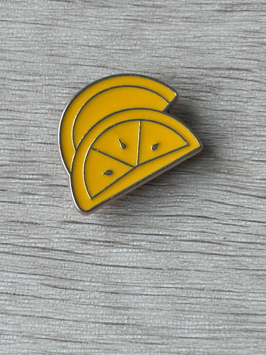 Broche en forme de tranche de citron jaune émaillée, contour blanc, motif facettes